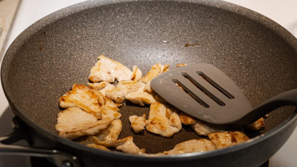 Stir-fried chicken breast in a large sautee pan