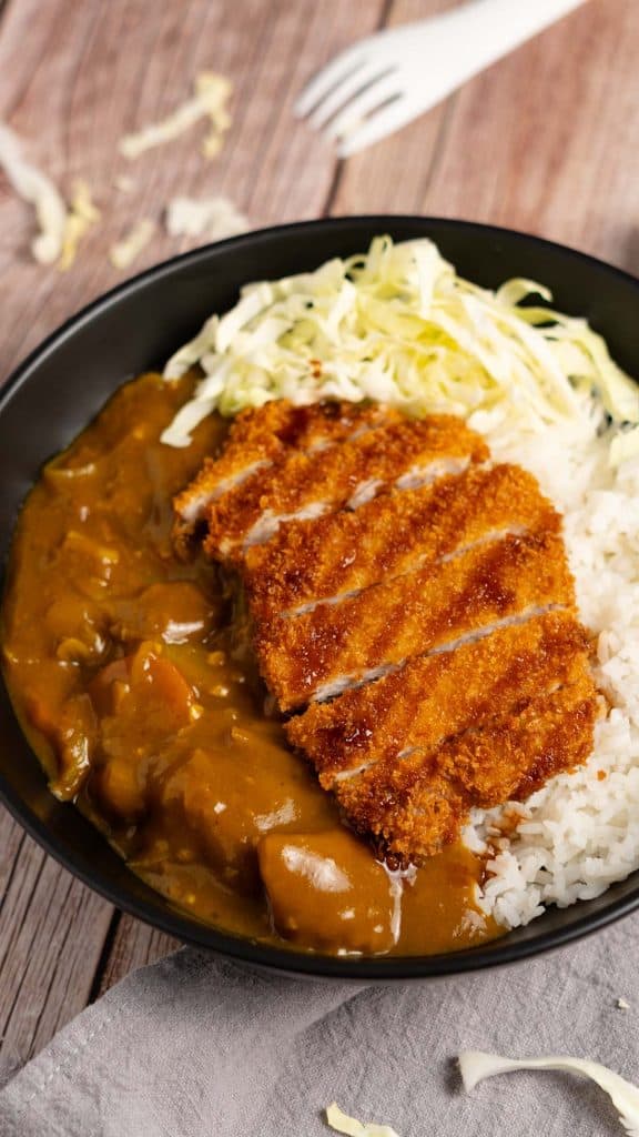 Pork cutlet on top of white rice and Japanese curry