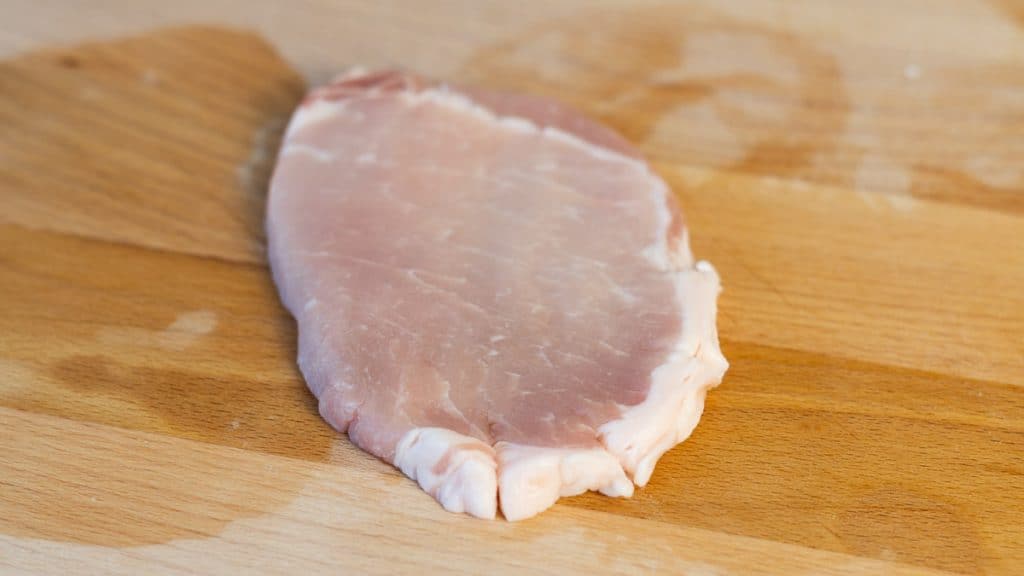 Pork cutlet with slits along connective tissue