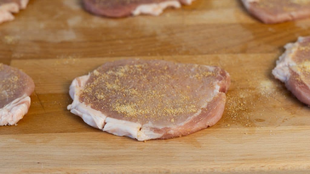 Slices of pork loin sprinkled with garlic powder, onion powder and salt