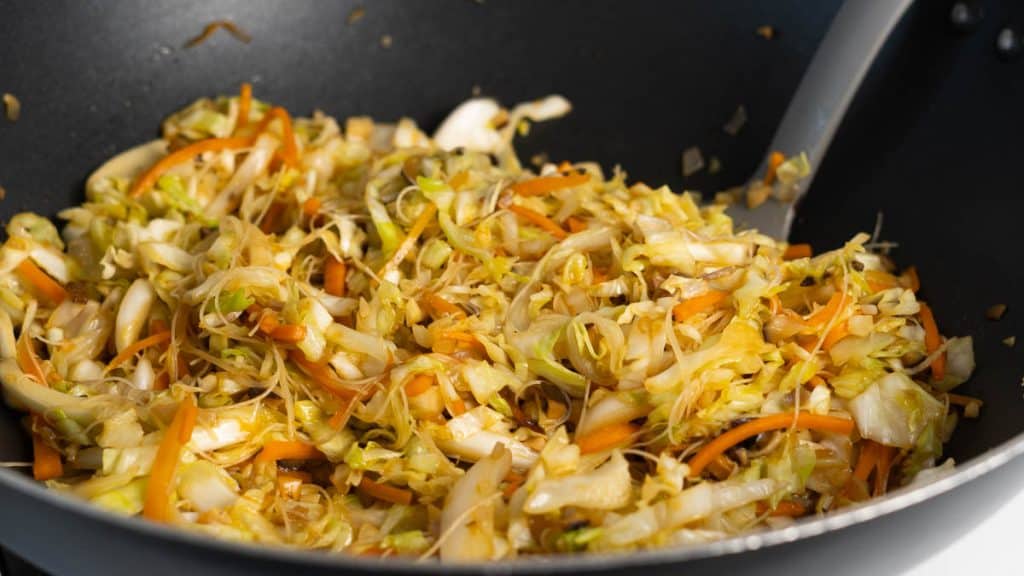 Stir fried shredded cabbage and carrots and minced shiitake mushrooms with rice vermicelli