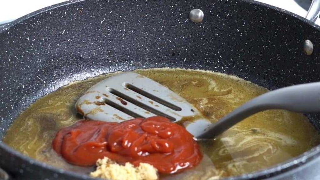 Ketchup, brown sugar, and soy sauce in melted butter and sake in a skillet