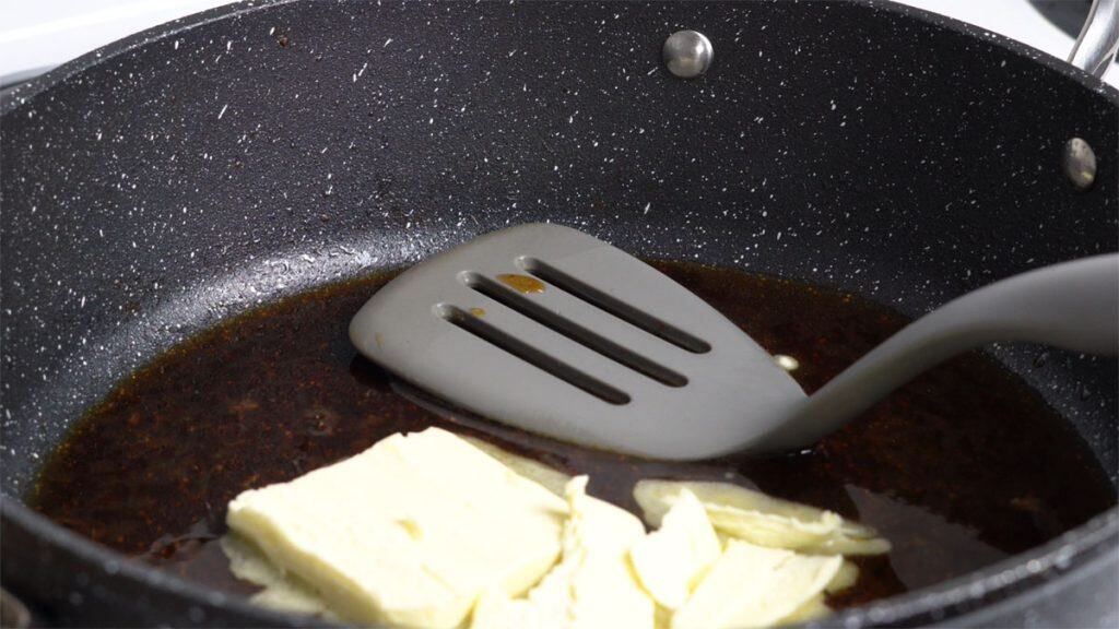 Melting butter in sake in a skillet