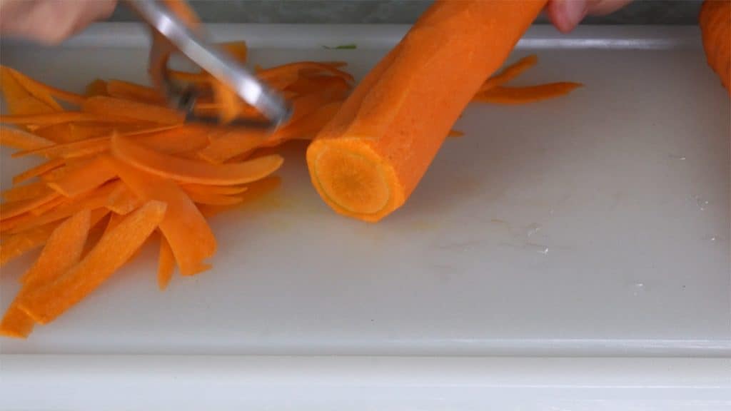 Peeling carrots with vegetable peeler