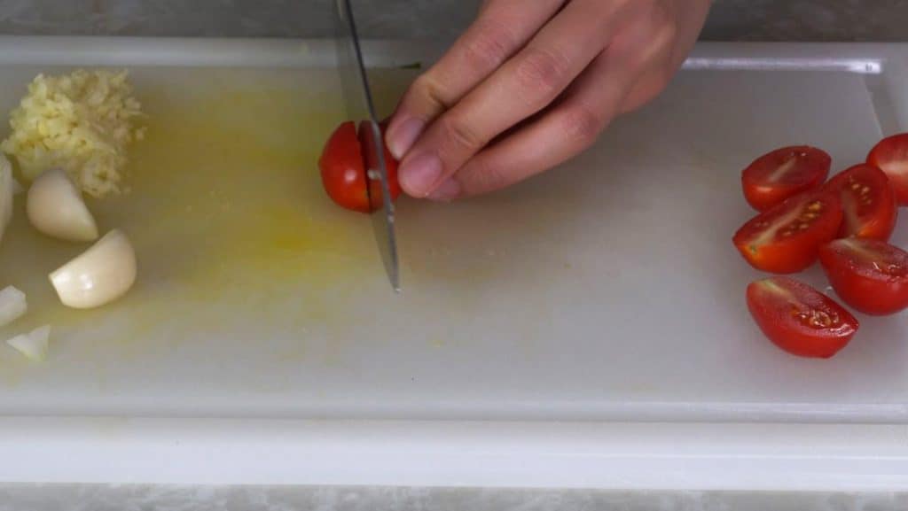 Slicing a grape tomato in half