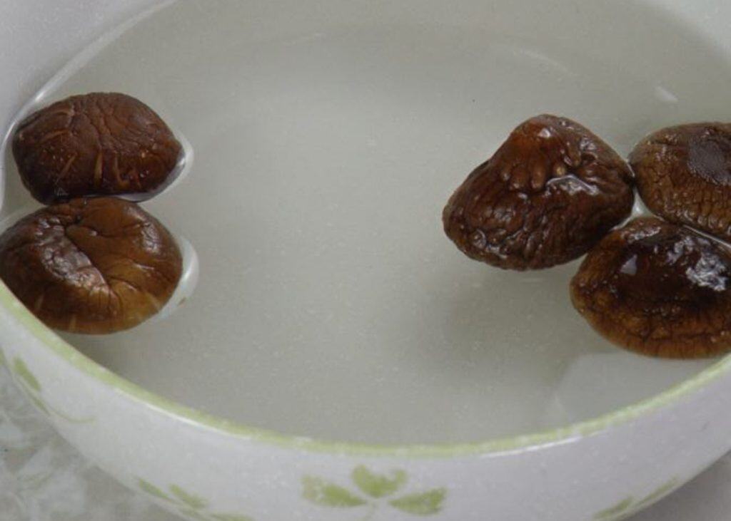 Dried shiitake mushrooms in a bowl of water