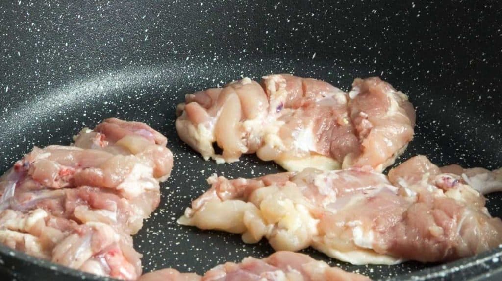 Frying chicken thighs with skin side down on a non-stick pan
