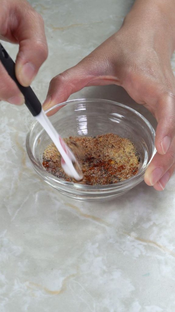 Mixing spices in a small glass bowl