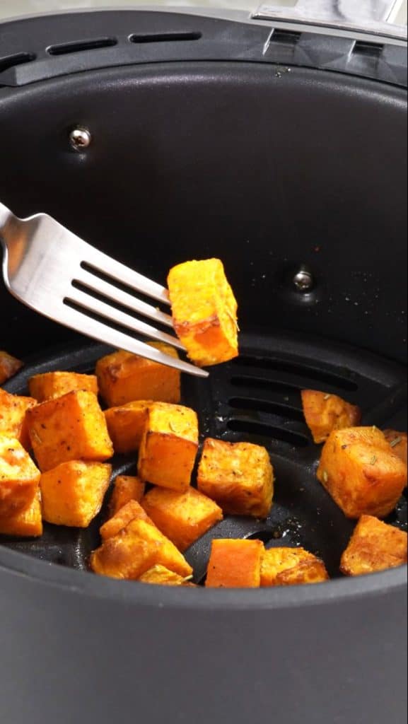 Air fried diced sweet potato in an air fryer basket