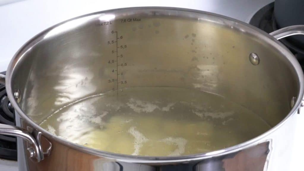 Boiling potatoes in a stainless steel saucepan on an electric stove