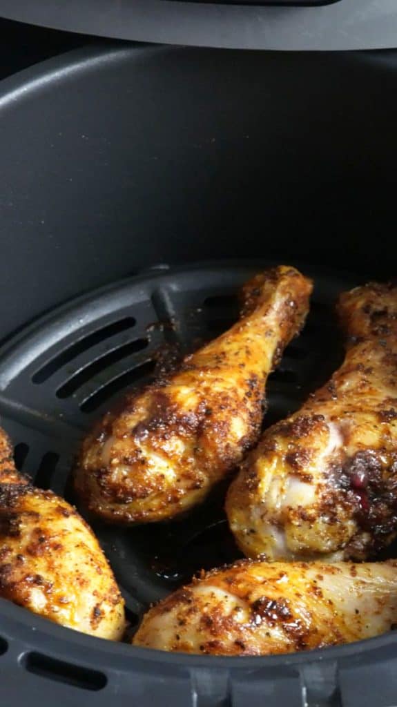 Air fried chicken drumsticks in an air fryer basket