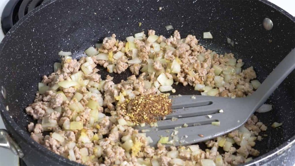 Sichuan peppercorn in ground pork and garlic, ginger and onion in a pan