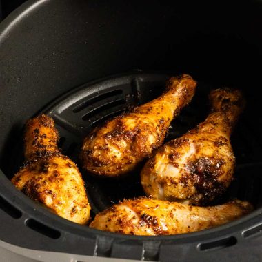 Air fried chicken drumsticks in an air fryer basket
