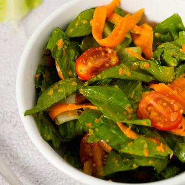 Japanese style salad with chopped romaine lettuce, carrot, grape tomatoes and ginger carrot dressing