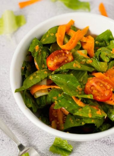 Japanese style salad with chopped romaine lettuce, carrot, grape tomatoes and ginger carrot dressing