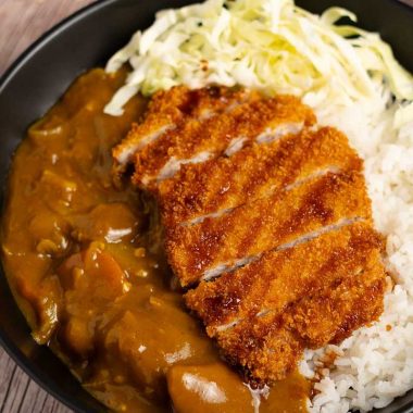 Japanese curry with pork katsu cutlet and shredded cabbage on steamed rice
