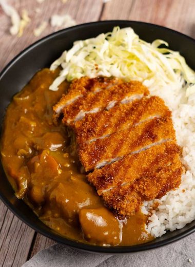 Japanese curry with pork katsu cutlet and shredded cabbage on steamed rice