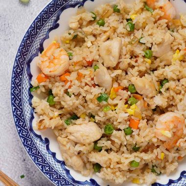 Shrimp and chicken fried rice with peas and carrots